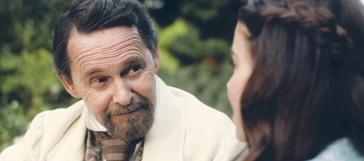 Elderly man chatting with a young girl